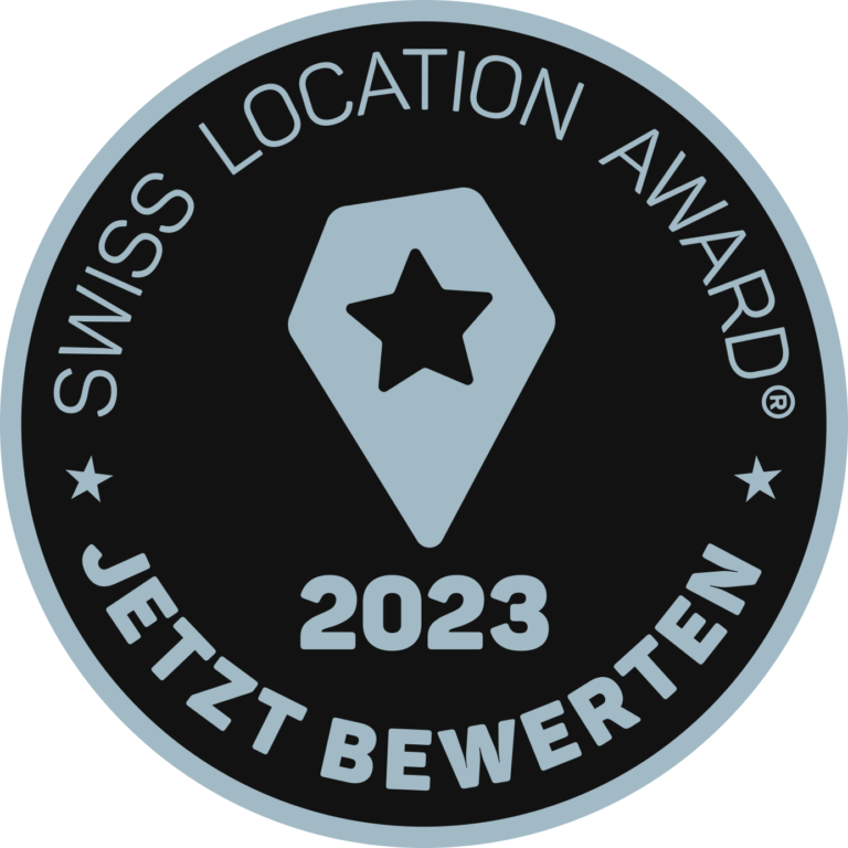 Das Bild zeigt einen Badge, der auffordert, das Gloria Coworking beim Swiss Location Award 2023 zu bewerten